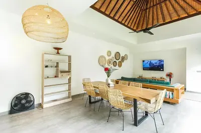 a dining room with a ping pong table and chairs at Villa GrandLux Bali 2 Bed Villa Pool Big Garden in Seminyak