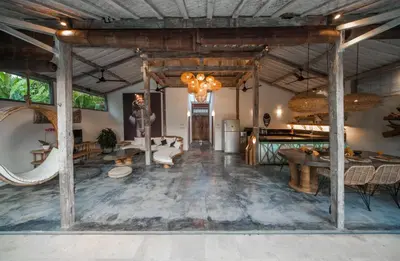 a large living room with wooden ceilings and a table at Villa Adagian - Magical 3BR Villa in Umalas in Canggu