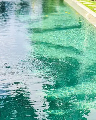 a swimming pool with green water in it at Villa Adagian - Magical 3BR Villa in Umalas in Canggu