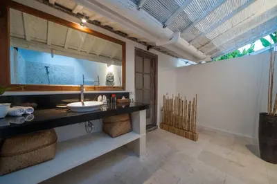 a bathroom with a sink and a mirror at Villa Adagian - Magical 3BR Villa in Umalas in Canggu
