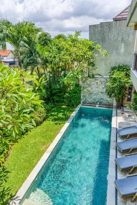 a swimming pool in the yard of a house at Virginia villa 4BR 5min walk to beach with assistant villa and pick up from airport and security in Canggu