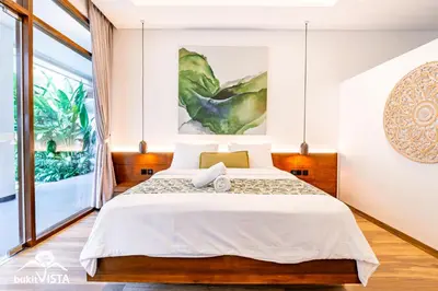a bedroom with a bed and a large window at Villa Marlex by Bukit Vista in Seminyak