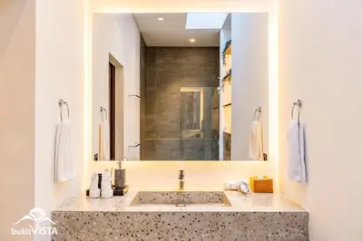 a bathroom with a sink and a large mirror at Villa Marlex by Bukit Vista in Seminyak