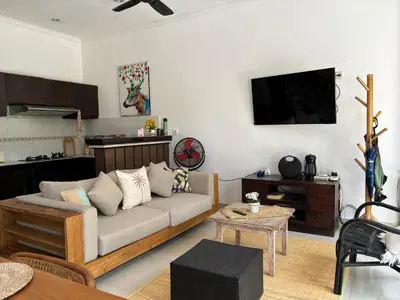 a living room with a couch and a table at Kubu D Kubu Villa - 3 Bedroom - Legian in Legian