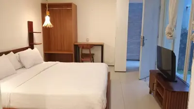 a bedroom with a bed and a flat screen tv at 3 BR Chrysanthemum Villa nusadua in Nusa Dua