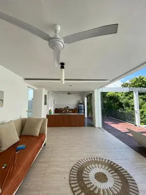a living room with a couch and a ceiling fan at 3 BR Chrysanthemum Villa nusadua in Nusa Dua