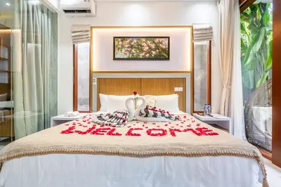 a bedroom with a bed with red roses on it at Villa Sun Lila by JB Villas in Seminyak