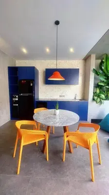 a dining room with a table and chairs and aendant light at Akhila 1 - 1 BR modern tropical villa at the heart of Seminyak in Seminyak