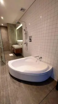 a large tub in a bathroom with a shower at Akhila 1 - 1 BR modern tropical villa at the heart of Seminyak in Seminyak