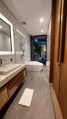 a bathroom with a shower and a sink and a tub at Akhila 1 - 1 BR modern tropical villa at the heart of Seminyak in Seminyak