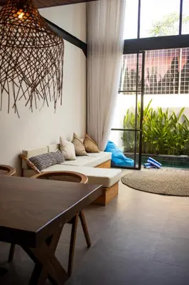 a living room with a couch and a table at Tropical Loft Steps Away from the Beach! Hidden GEM! in Canggu
