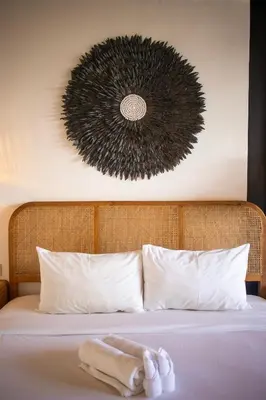 a bed with a towel sitting on top of it at Tropical Loft Steps Away from the Beach! Hidden GEM! in Canggu