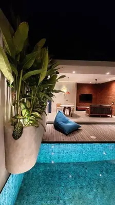a large potted plant sitting next to a pool at Akhila 4 - 1 BR modern tropical villa at the heart of Seminyak in Seminyak