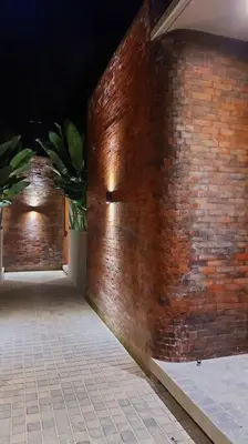 a brick wall with a door in a building at Akhila 4 - 1 BR modern tropical villa at the heart of Seminyak in Seminyak