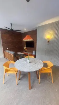 a dining room with a table and two chairs at Akhila 5 - 1 BR modern tropical villa at the heart of Seminyak in Seminyak