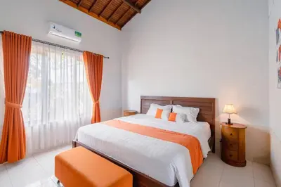a bedroom with a large bed and a window at Private 3 Bedroom Villas, 5 mnt to Beach Nusa Dua in Nusa Dua