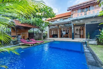 a swimming pool in front of a house with a villa at Private 3 Bedroom Villas, 5 mnt to Beach Nusa Dua in Nusa Dua