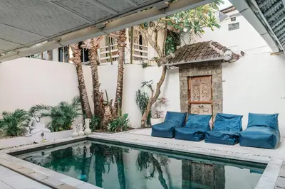 a swimming pool with blue pillows next to a building at Seminyak Villa, Pool, 2 min to Double Six Beach in Seminyak