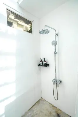 a shower in a white bathroom with a shower head at Seminyak Villa, Pool, 2 min to Double Six Beach in Seminyak