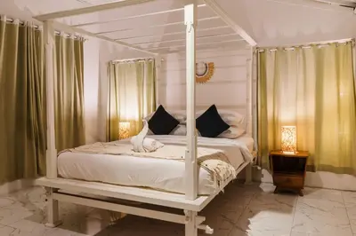 a white canopy bed with a white cat sitting on it at Seminyak Villa, Pool, 2 min to Double Six Beach in Seminyak