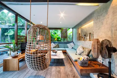 a living room with a large rattan hanging chair at Anggana Villa 2 in Canggu