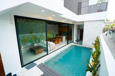 a house with a swimming pool in the backyard at Pradha Kuta, 3 BDR, 3 minutes from seminyak beach in Seminyak