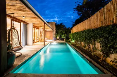 a swimming pool in the backyard of a house at Anggana Villa 3 in Canggu