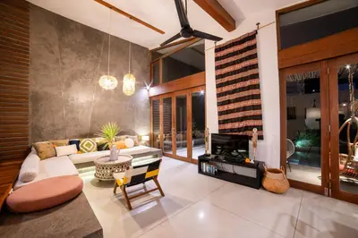 a living room with a couch and a fireplace at Anggana Villa 3 in Canggu