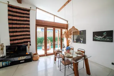 a living room with a table and chairs and a television at Anggana Villa 3 in Canggu