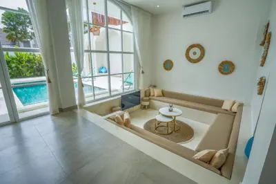 a large bathroom with a tub and a table at Stunning tropical 3bed Villa in Canggu