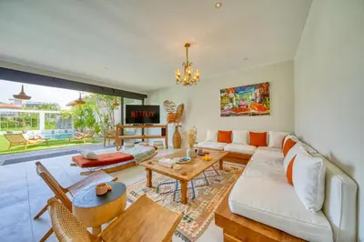 a living room with a couch and a table at Chic Tranquility Modern yet Timeless 3BD Villa in Canggu
