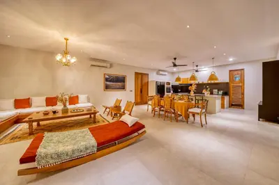 a living room with a bed and a dining room at Chic Tranquility Modern yet Timeless 3BD Villa in Canggu