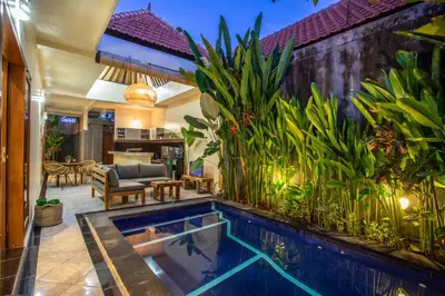 a swimming pool in a backyard with plants at Villa Shiro in Seminyak