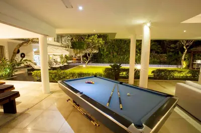 a pool table in the middle of a living room at CassaMia Bali - Spacious Luxury 5 Bedroom Villa in Jimbaran
