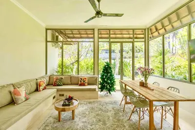 a living room with a couch and a table at Mantra Dom Villa 3 Bedrooms in Canggu