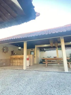 a house with a table and a bench in front of it at Sorry we close in Seminyak