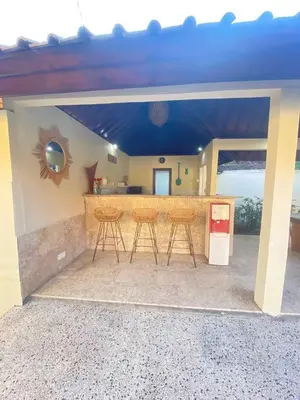a patio with a bar with stools in front of a house at Sorry we close in Seminyak