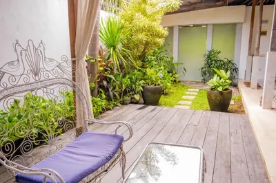 a porch with a bench and a mirror on it at Villa Marie Clare in Seminyak