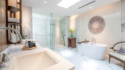 a large bathroom with a tub and a sink at Des Indes Villas in Seminyak