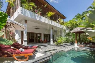 a villa with a swimming pool and a house at 2 Bedroom Private Pool walking distance to the Seminyak beach in Seminyak