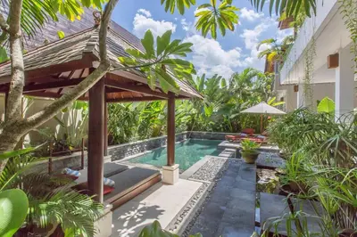 a courtyard with a swimming pool in a villa at 2 Bedroom Private Pool walking distance to the Seminyak beach in Seminyak
