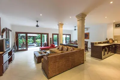 a large living room with a couch and a kitchen at 2 Bedroom Private Pool walking distance to the Seminyak beach in Seminyak