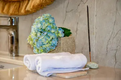 a bathroom counter with a towel and a hydrants at Kubung 1 - Villa with HUGE Pool and PS5 in Kerobokan