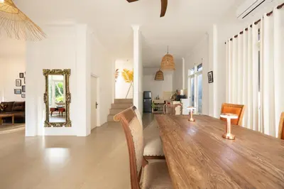 a dining room with a wooden table and chairs at Villa Selamat, Seminyak, Batu Belig, 10 min from beach in Seminyak