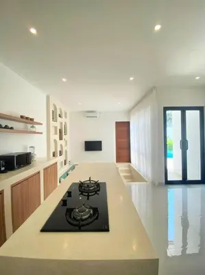 a kitchen with a black stove top in a room at Cosy 2bed/2bath villa 5 min to beach in Dalung