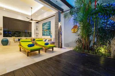 a living room with green chairs and a couch at Villa Céline 1 Bdr pool Seminyak in Seminyak