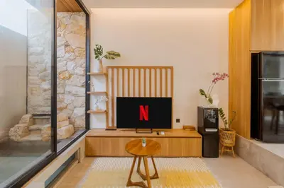 a living room with a tv with the letter n on it at Vin Villa Seminyak 2BR with Private Pool in Seminyak