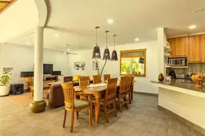 a kitchen and dining room with a table and chairs at Rose 2BR Private Pool Villa in Kerobokan