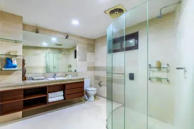 a bathroom with a glass shower and a toilet at Rose 2BR Private Pool Villa in Kerobokan