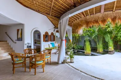 a dining room with a table and chairs at Hazel Azalea 4 BR Private Pool Villa in Seminyak
